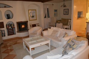 Cosy sitting room in the main house in the winter with a wood burning stove.