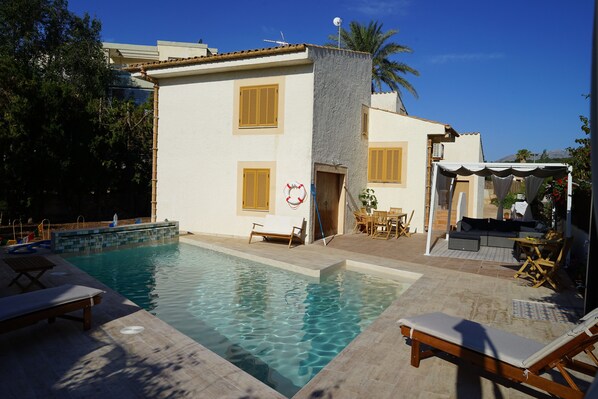 The newly completed private pool and sun terraces to the rear of the villa