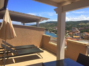 Sheltered balcony with table and chairs for 4 people and sea views