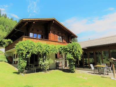 Chalet La Taupiniere from the garden, showing the pool room and terrace.