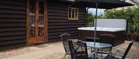 The private rear garden with hot tub, outside dining and BBQ