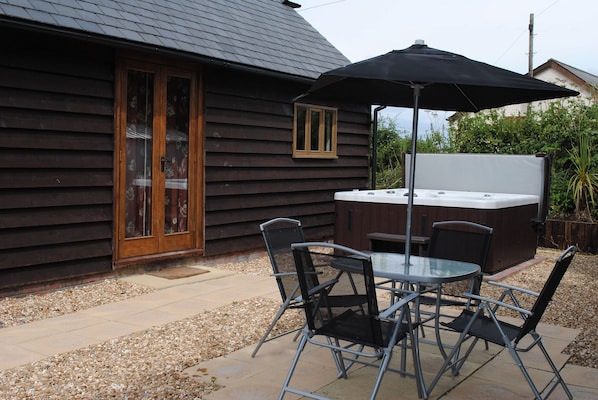 The private rear garden with hot tub, outside dining and BBQ