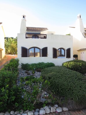 Front of villa showing garden and first floor balcony