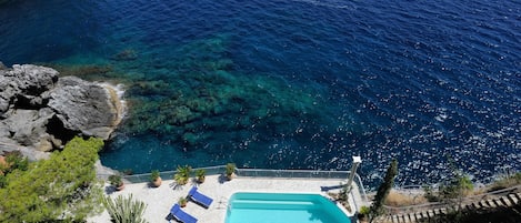 Private swimming pool with sun chairs