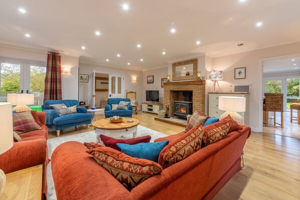 Waterside, Wiveton: Sitting room with wood burning stove