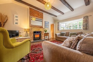 Toad Hall, Burnham Deepdale: Sitting room with wood burning stove