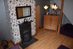  32" TV in the cabinet. Lighting via central chandelier and dimmable upstander.