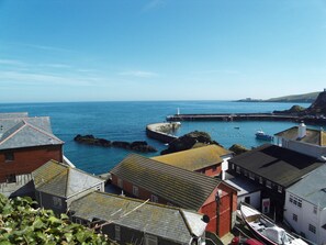 View from outside the cottage looking to the outer harbour and lighthouse