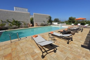 Relax on one of the many sun loungers around the pool area