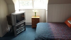 Bed and TV in attic suite