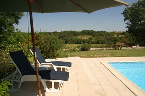 View over the valley. Two terraces, loungers, cushions and parasols.