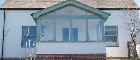 Front of house. Sunroom with stunning sea views!