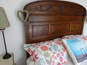 A lovely Spanish antique headboard with the King bed overlooking the lemon trees