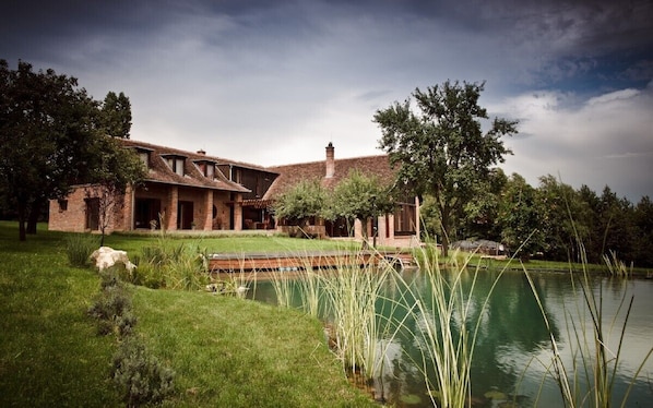 View of the house and the swimming lake outside