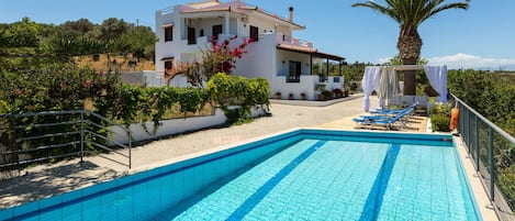 Outdoors area with swimming pool, sun beds, sun umbrellas and outdoor furniture!