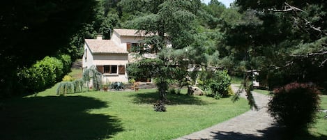 Front of property set in large private gardens and wildlife