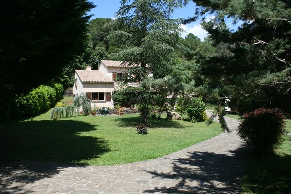 Front of property set in large private gardens and wildlife