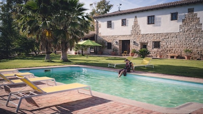 Typical Andalusian farmhouse surrounded by olive and fruit trees