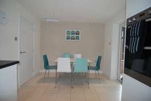 Modern dining area and patio doors to conservatory