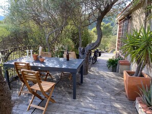 Outdoor- Eating area overlooking Puig del Mas countryside with extendable table