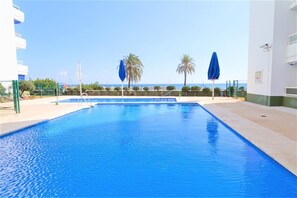 Community swimming pool with sea views 