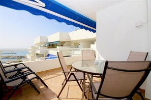Balcony with sea views, dining for 4 and relaxer seating