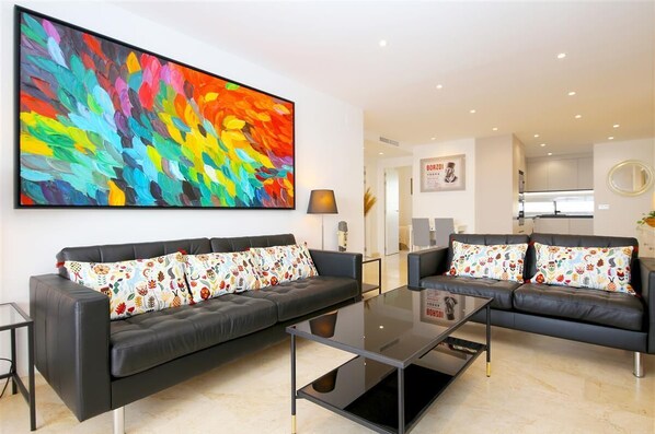 Modern open plan lounge with access to the terrace