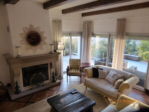 Living room opening onto front terrace with views over the village 