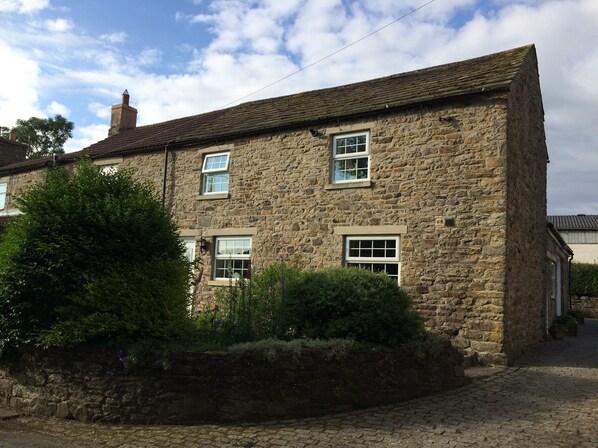 The front of the cottage which over looks the river and weardale railway.