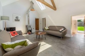 The Nurseries, Syderstone: Sitting room with feature wood burning stove and vaulted ceiling