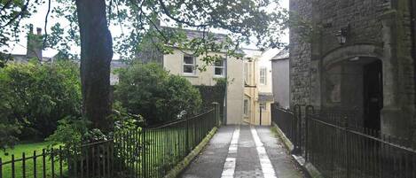 View of cottage from lane through All Saints Church