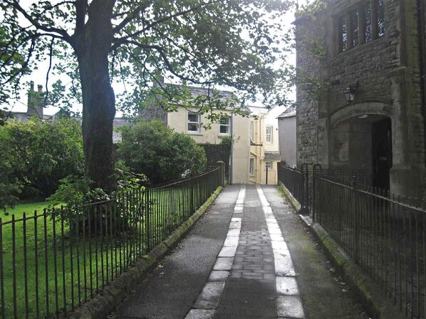 View of cottage from lane through All Saints Church