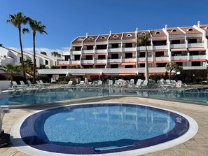 Pool for young children, safely separated from main pool by clear screen.