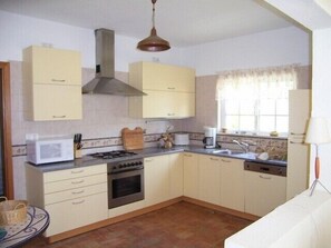 Fully equipped modern kitchen with storage room
