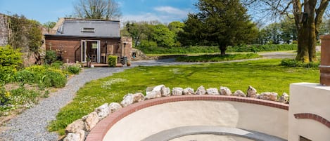 The Old Boiler House and firepit sit secluded within a Victorian Walled Garden.