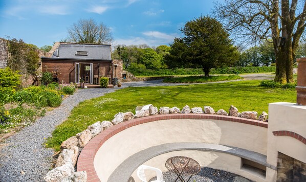 The Old Boiler House and firepit sit secluded within a Victorian Walled Garden.