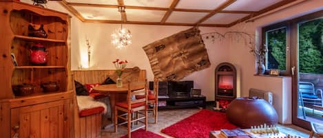 Cosy living room and dining area with sofa bed leading onto a large balcony.