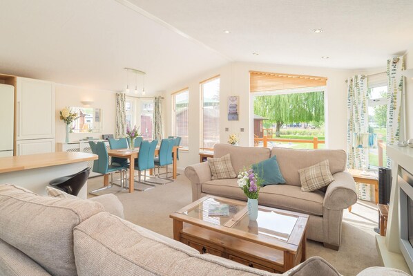 Spacious, bright, open plan living with doors on to the decking and river views