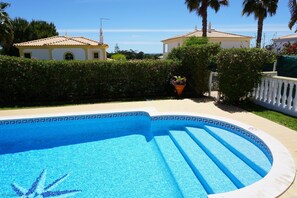 Estrelicia's very private pool surround with high shrubs, pretty garden, lawn & sea views.