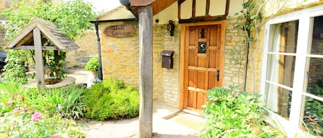 Welcome!
Oak front door to Well Cottage with canopy over the door.  