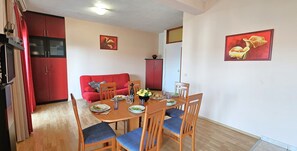 Open plan living/dining/kitchen area opening into sea view terrace