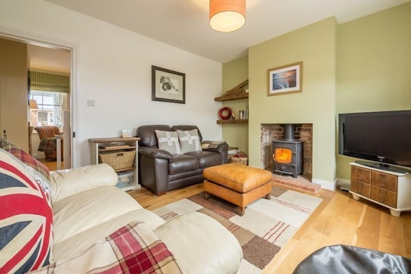 Langley's Cottage, Heacham: Sitting room featuring a wood-burning stove and comfy seating