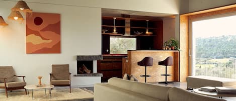 Living room with bar and second kitchen. Panoramic view over the village/valley.