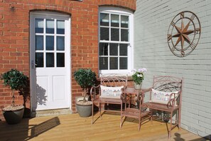 Morning coffee sun trap on back decking.
