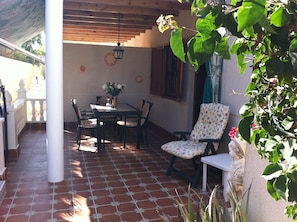 View across the terrace, looking towards the front door and the outside table.