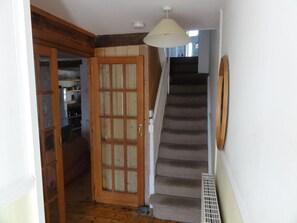 Hallway leading into living room or upstairs.