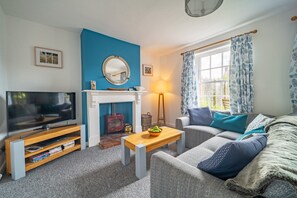 1 Dix Cottage, Thornham: Sitting room with wood burning stove