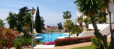 Manicured gardens pool + child pool sea beyond