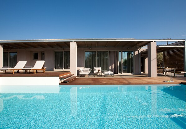 Relax on the hardwood sundeck next to the Pool