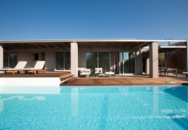 Relax on the hardwood sundeck next to the Pool